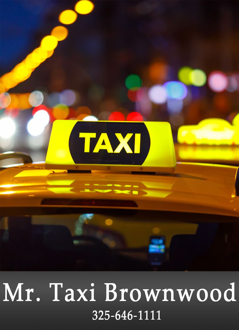 Picture of a  yellow Taxi sign with blurry city lights in the background